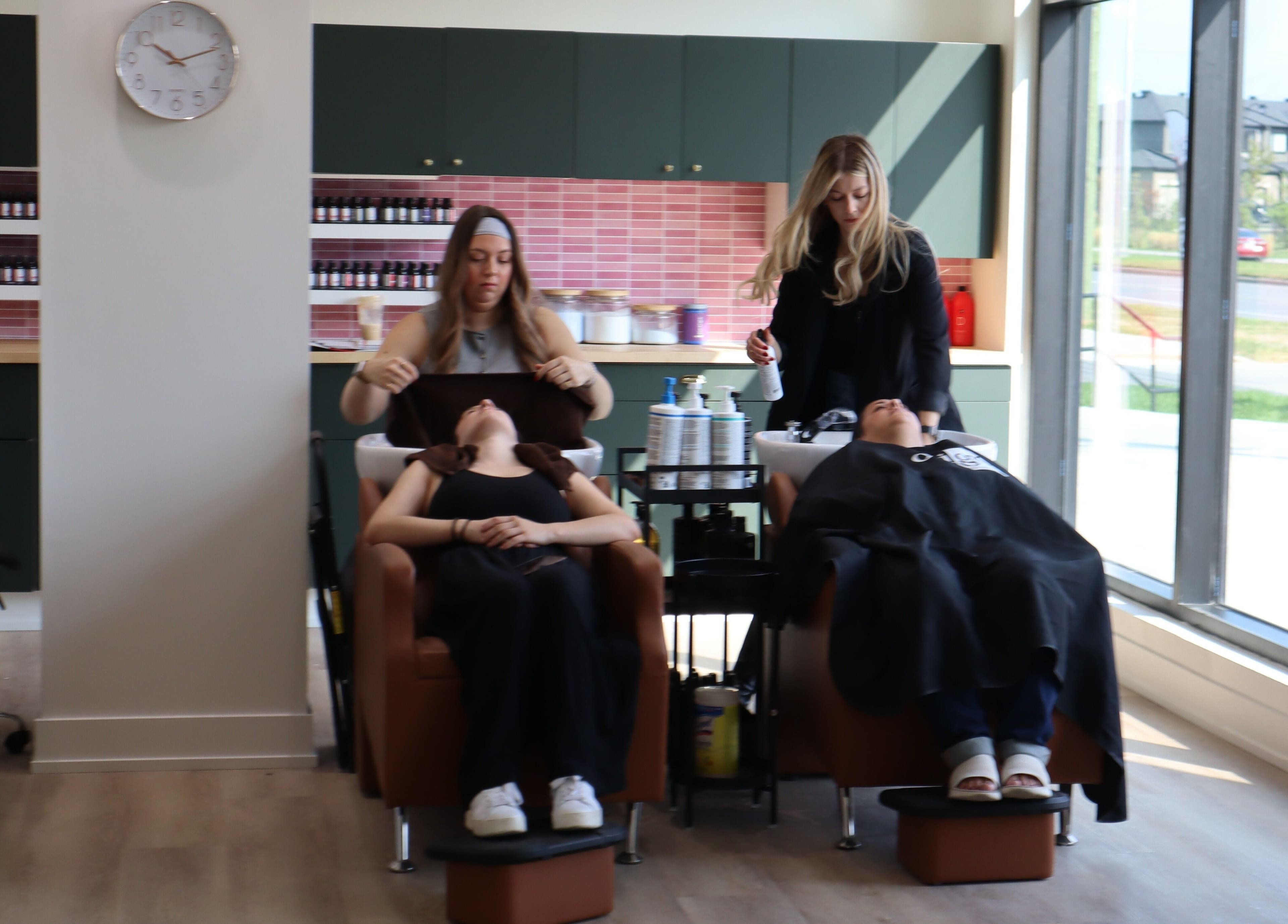 Stylists attending clients at Fika Beauty East salon in Ottawa, Ontario, CA.