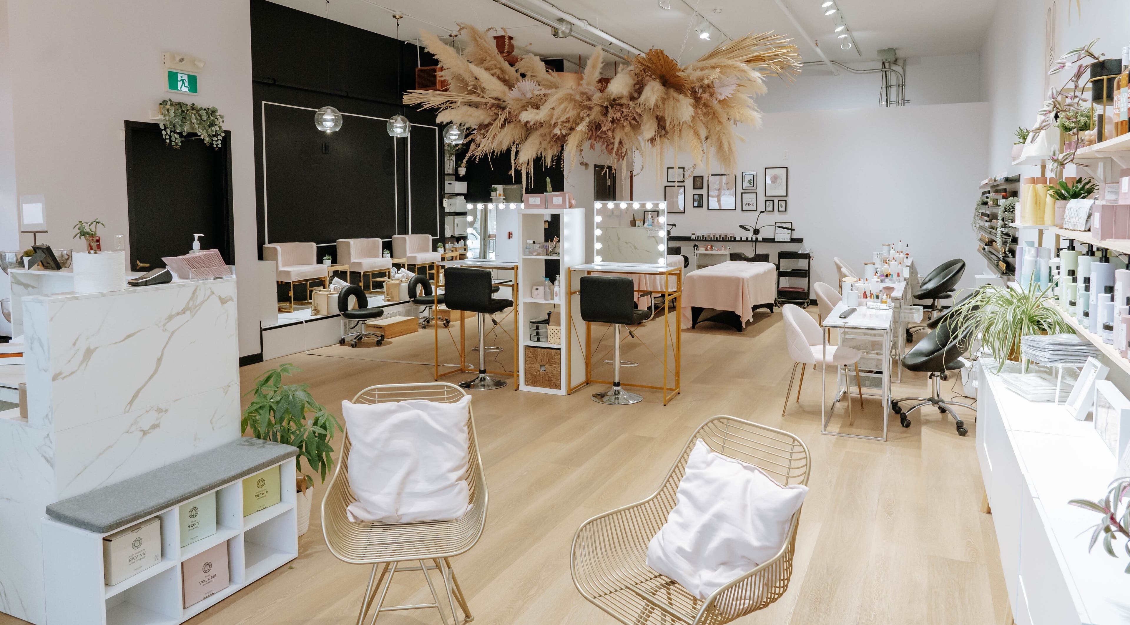 Elegant interior of Fika Beauty West in Ottawa, Ontario, CA with modern chairs, mirrors, and decor.