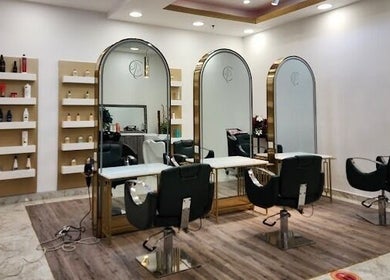 Elegant interior of Companion Beauty Salon Badia Branch in Dubai, AE featuring modern styling chairs and mirrors.