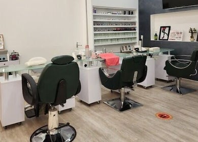 Modern nail salon interior at Companion Beauty Salon Badia Branch, Dubai, AE, featuring stylish seating and manicure stations.