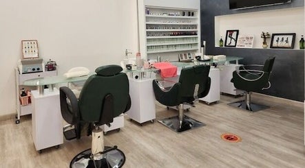 Modern nail salon interior at Companion Beauty Salon Badia Branch, Dubai, AE, featuring stylish seating and manicure stations.