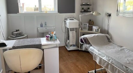 Cozy treatment room at Body 2 Soul, Tewkesbury, England, GB, featuring a massage bed and skincare equipment.