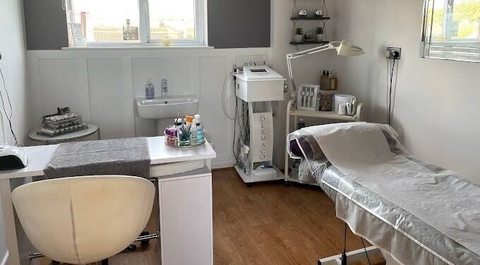 Cozy treatment room at Body 2 Soul, Tewkesbury, England, GB, with massage bed and skincare equipment.