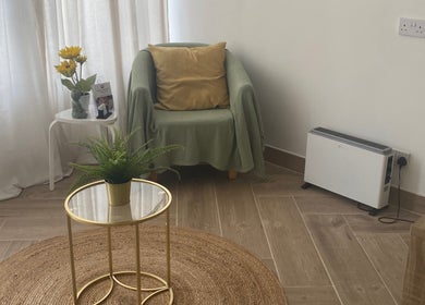 Relaxing seating area at Balancing Touch Complementary Therapies, Risca, Wales, GB. Sunflower decor and greenery.