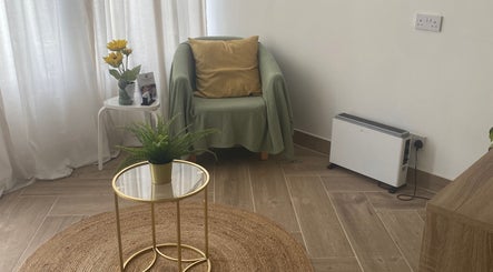 Relaxing seating area at Balancing Touch Complementary Therapies, Risca, Wales, GB. Sunflower decor and greenery.