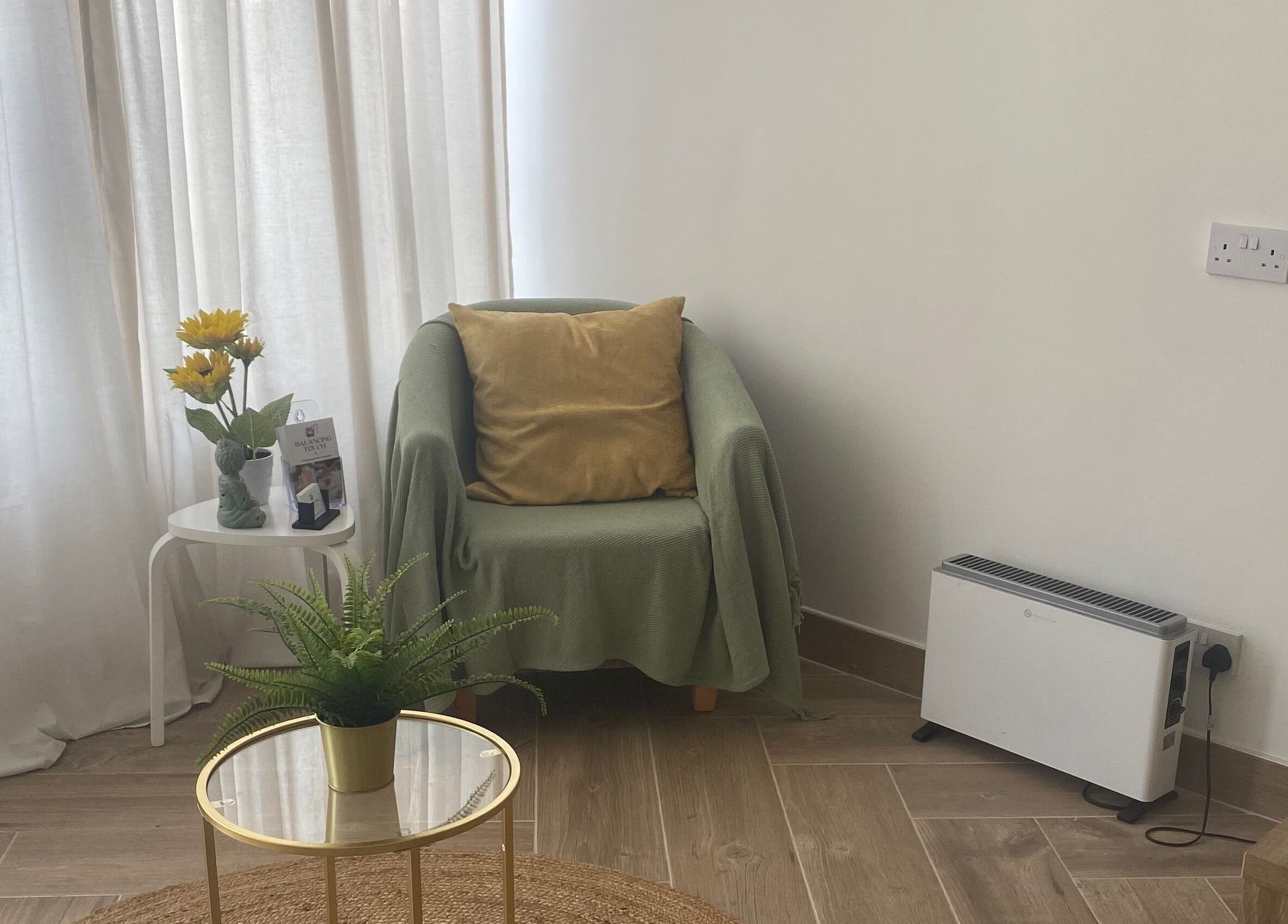 Calming therapy room at Balancing Touch Complementary Therapies, Risca, Wales, GB featuring cozy chair and plants.