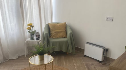 Calming therapy room at Balancing Touch Complementary Therapies, Risca, Wales, GB featuring cozy chair and plants.