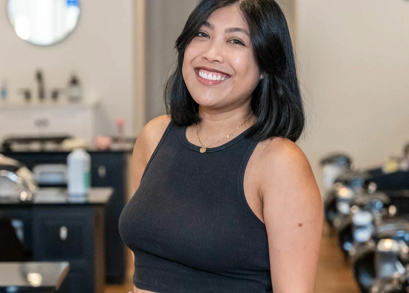 Friendly staff member at Onyx Nail Bar in Voorhees Township, New Jersey, US, welcoming guests with a smile.