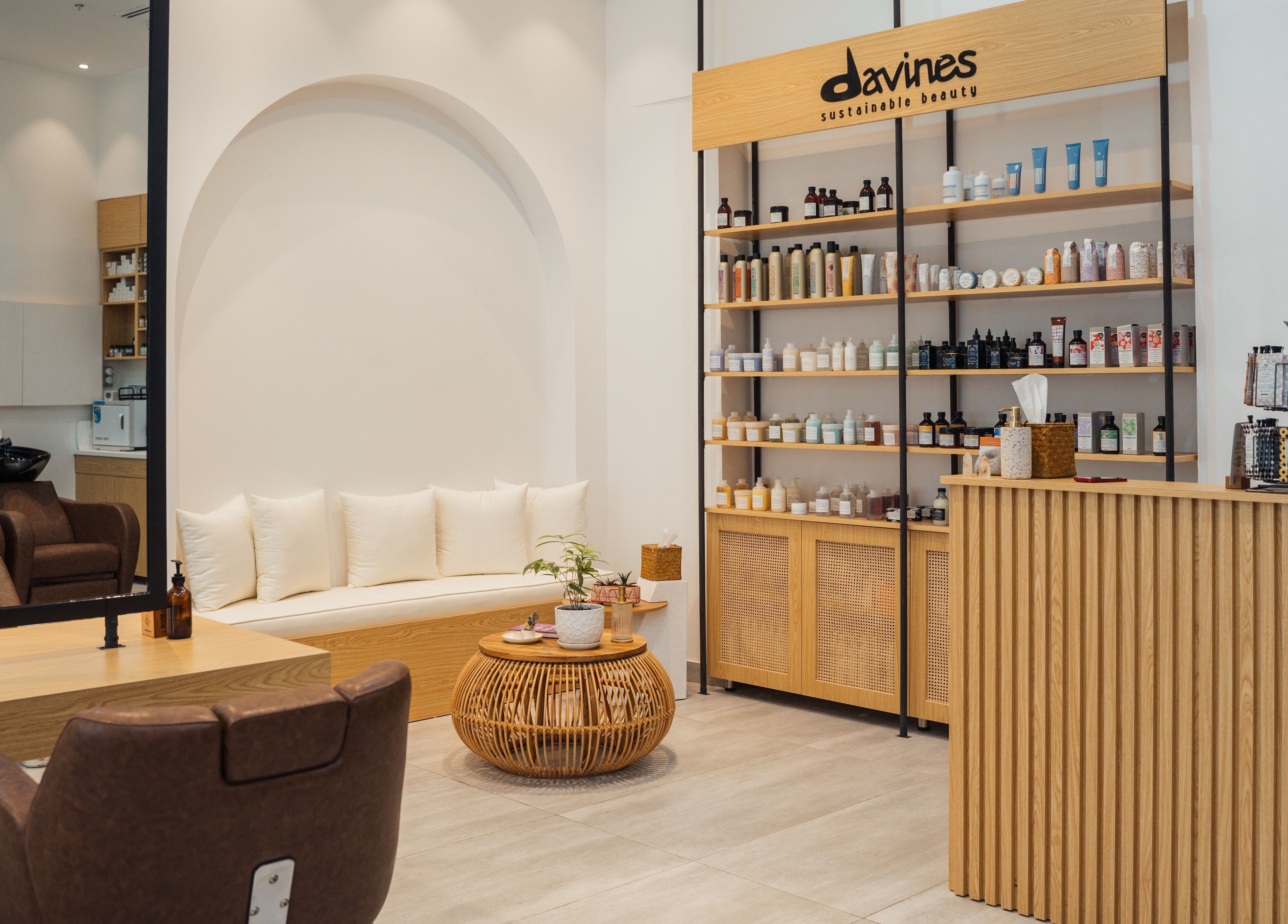 Interior of Boho Salon AD, Abu Dhabi, AE showcasing modern seating and product shelves in elegant decor.