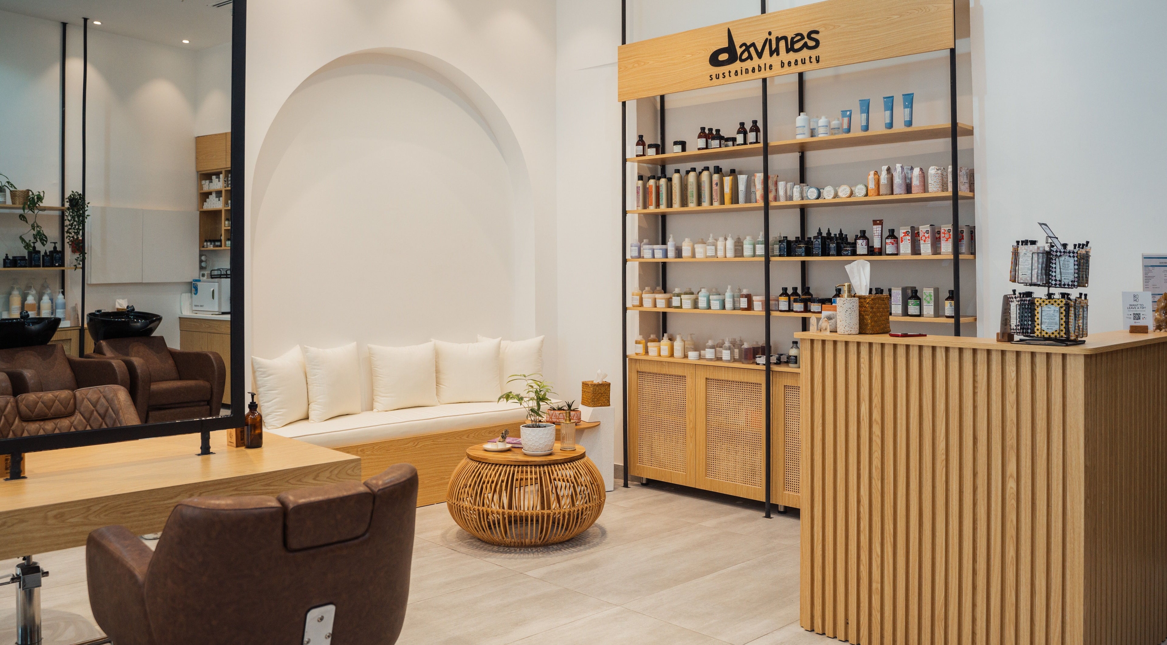 Interior of Boho Salon AD, Abu Dhabi, AE showcasing modern seating and product shelves in elegant decor.