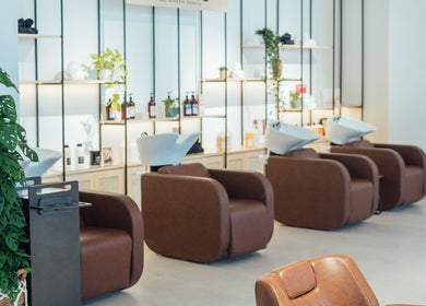 Modern salon chairs and lush plants at Boho Salon DXB, Dubai, Dubai, AE, offering luxurious beauty services.