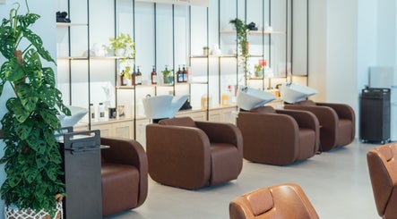 Modern salon chairs and lush plants at Boho Salon DXB, Dubai, Dubai, AE, offering luxurious beauty services.