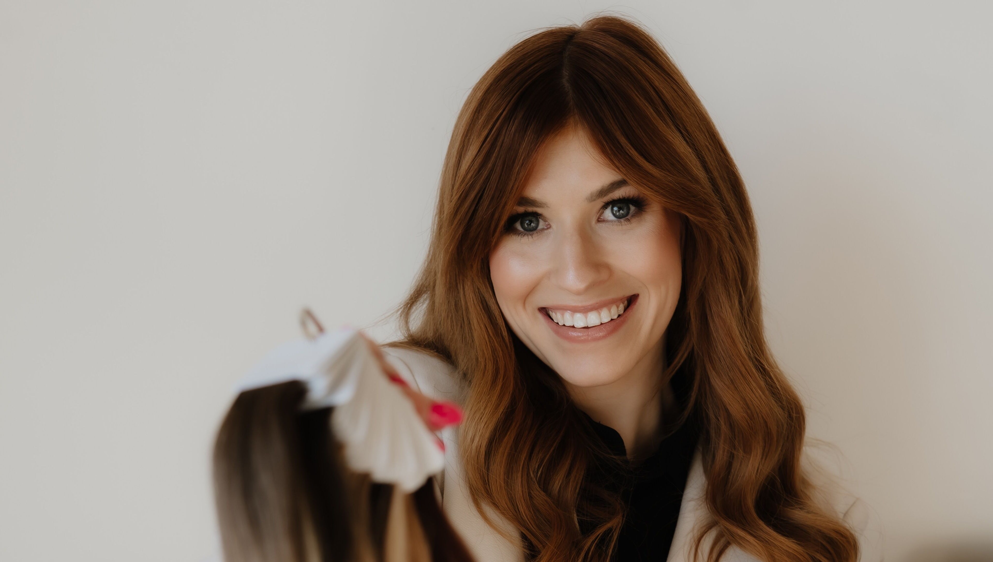 Smiling woman at Paige at Chic, Moose Jaw, Saskatchewan, CA, showcasing beauty services.