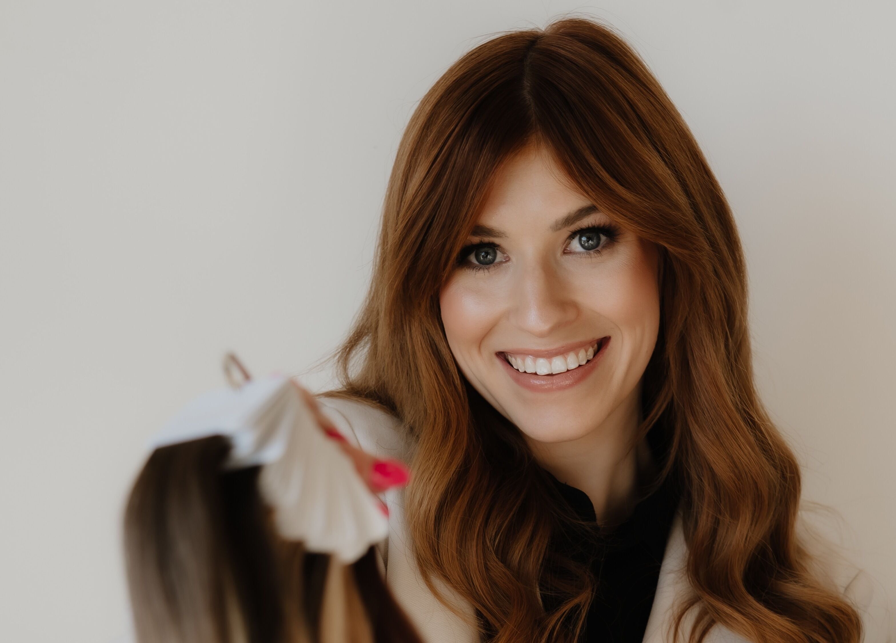 Smiling woman at Paige at Chic, Moose Jaw, Saskatchewan, CA, showcasing beauty services.