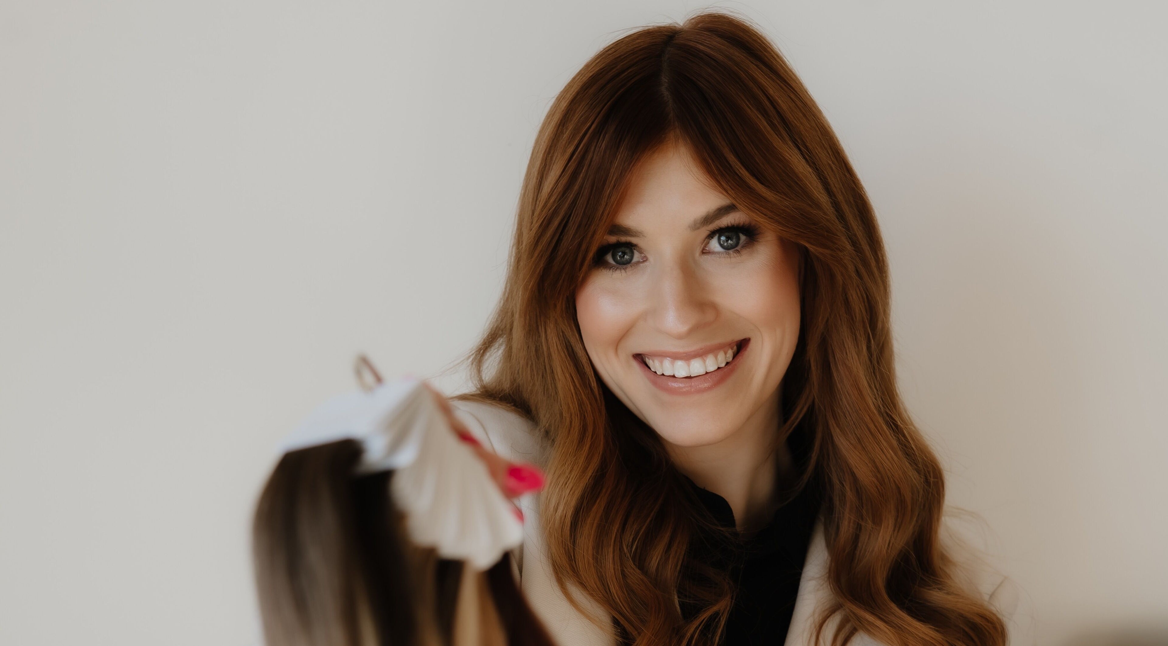 Smiling woman at Paige at Chic, Moose Jaw, Saskatchewan, CA, showcasing beauty services.