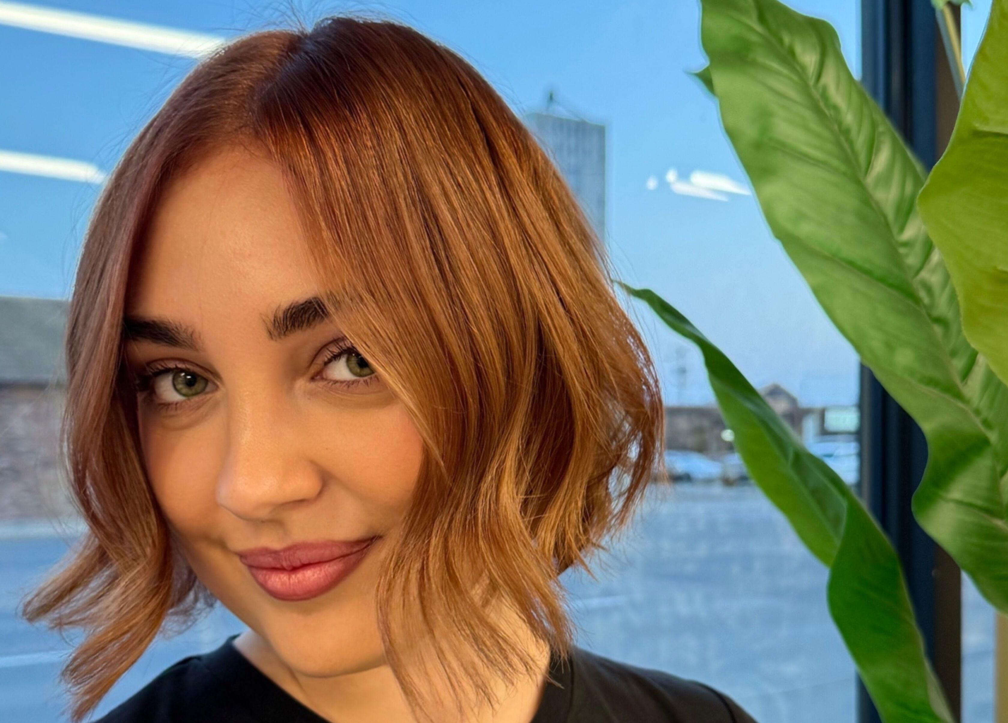 Woman with stylish haircut at Paige at Chic, Moose Jaw, Saskatchewan, CA, showcasing modern salon aesthetics.