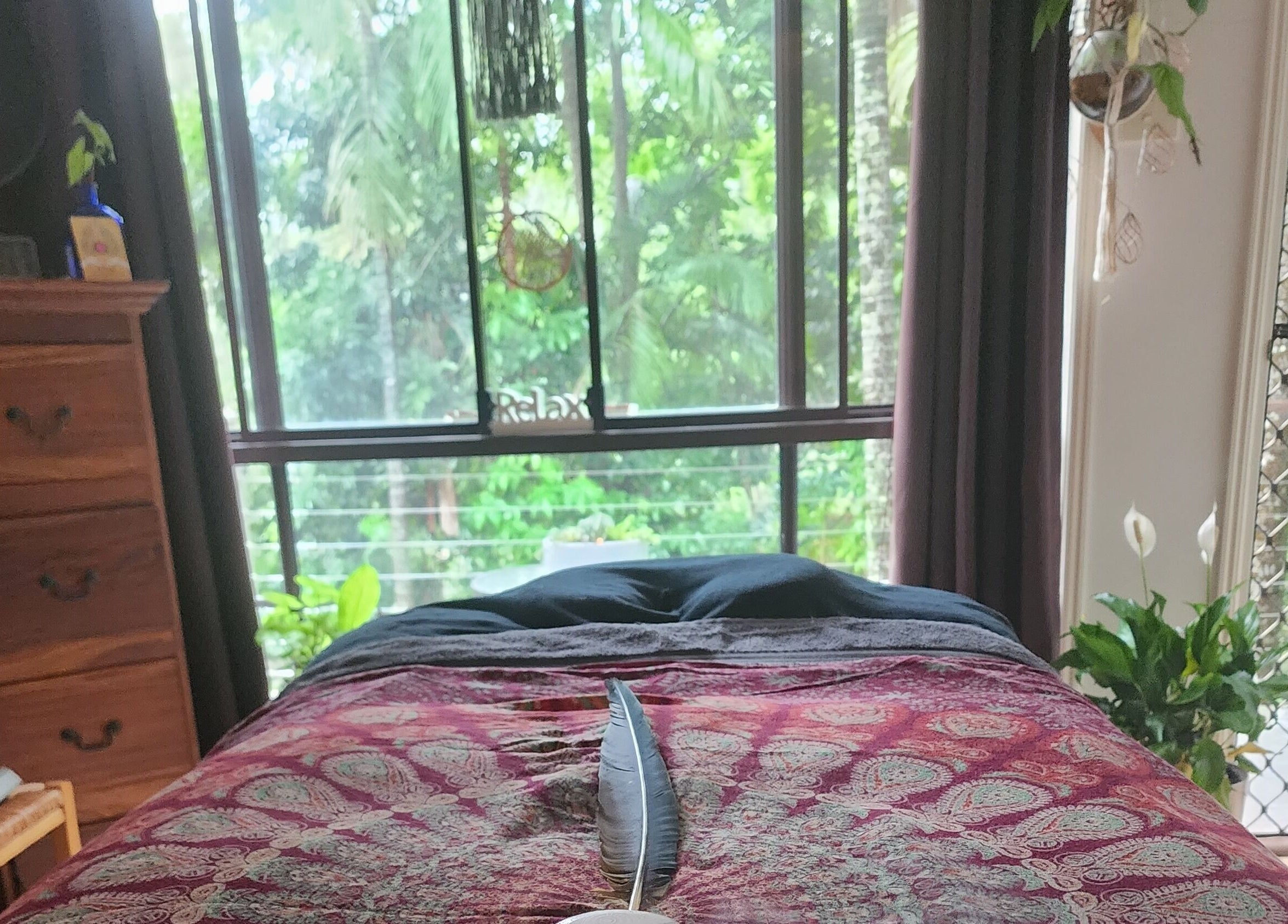 A serene spa room at Earth Magic with Suzie Maxwell, Currumbin Waters, Queensland, AU, featuring lush greenery.