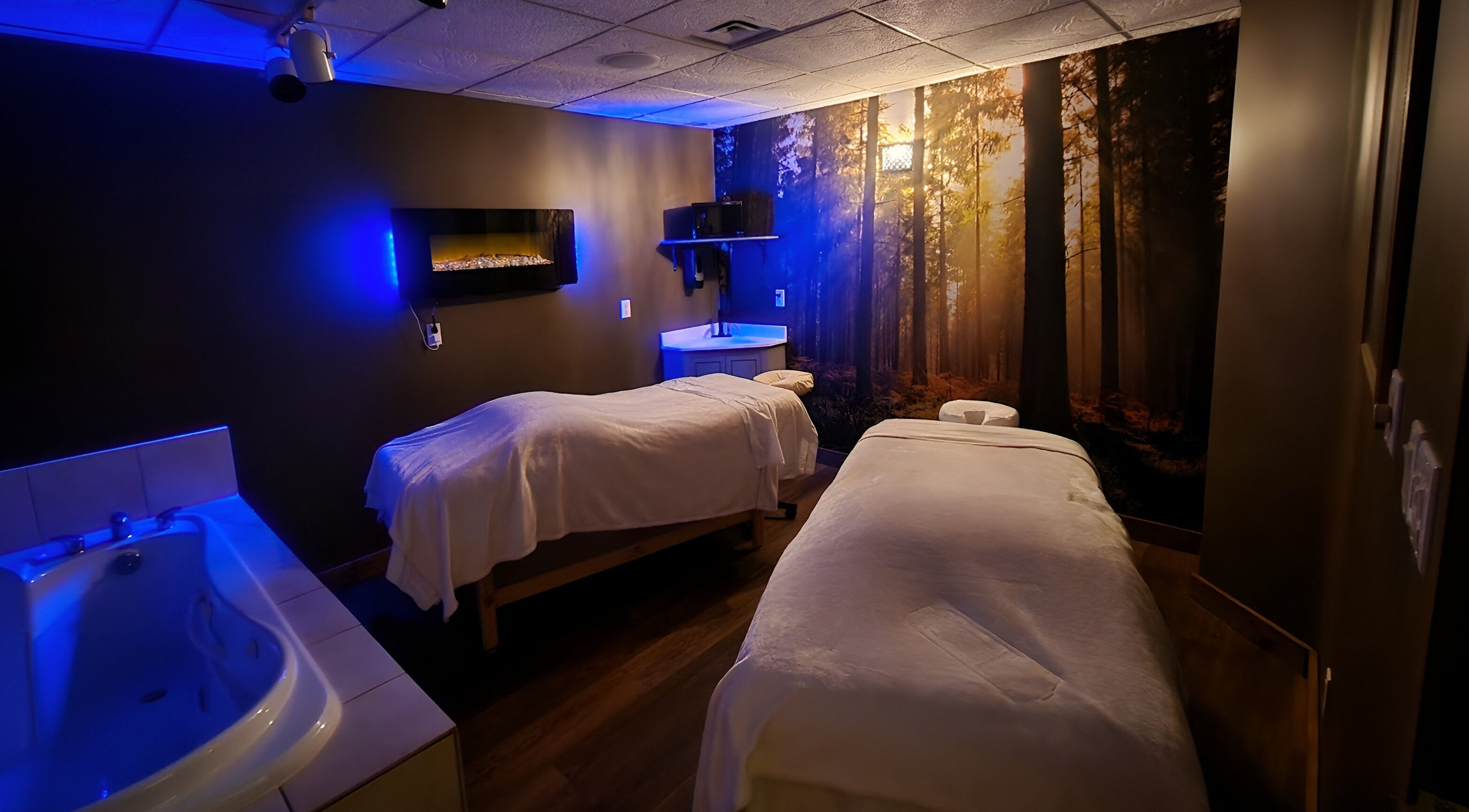 Relaxing spa room at Eganridge Resort in Kawartha Lakes, Ontario, CA with cozy beds and ambient lighting.