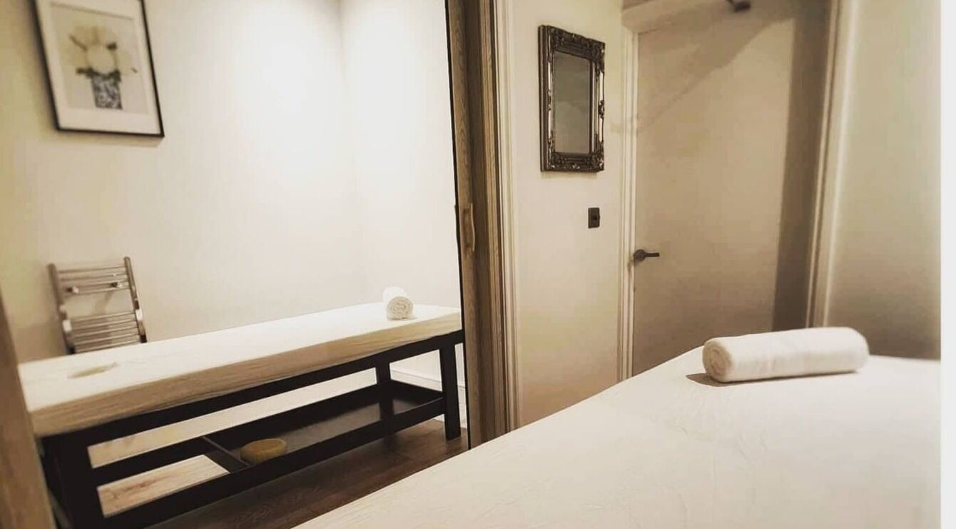 Tranquil massage room at Siam Zenith Spa & Beauty in London, England, GB with warm lighting and plush tables.