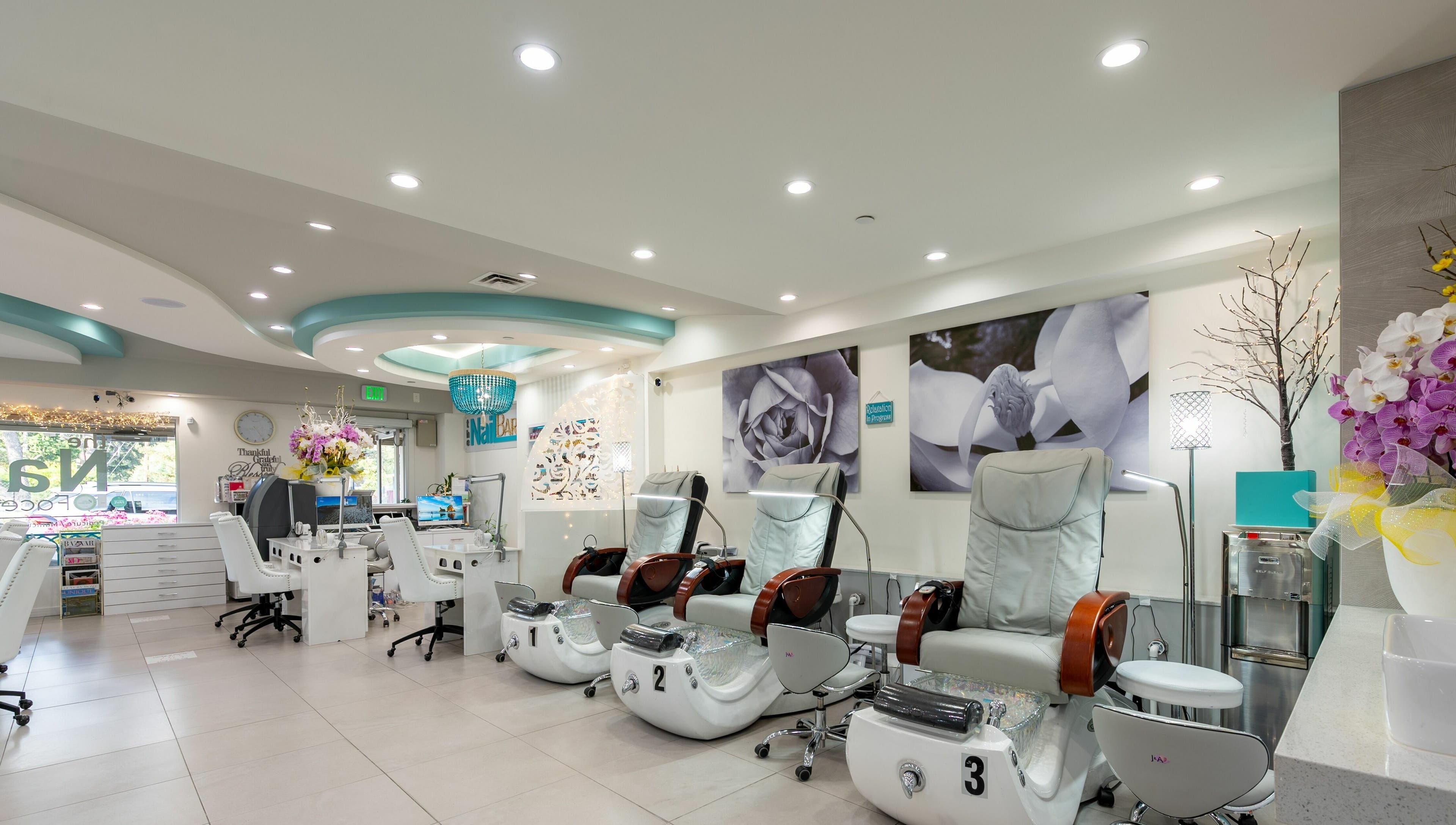 Luxurious interior of The Nail Bar Los Altos, California, US, featuring modern pedicure chairs.