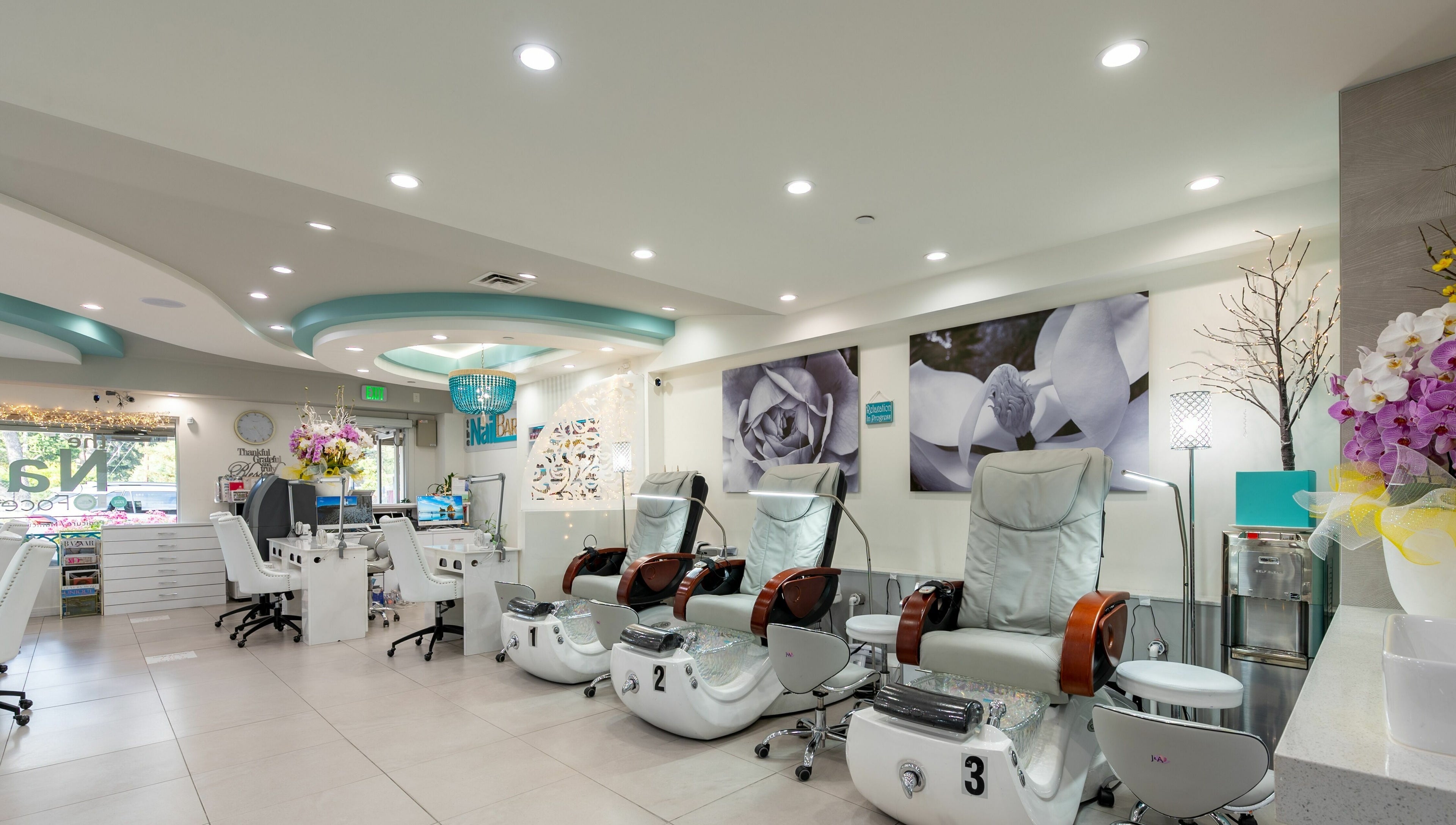 Luxurious interior of The Nail Bar Los Altos, California, US, featuring modern pedicure chairs.