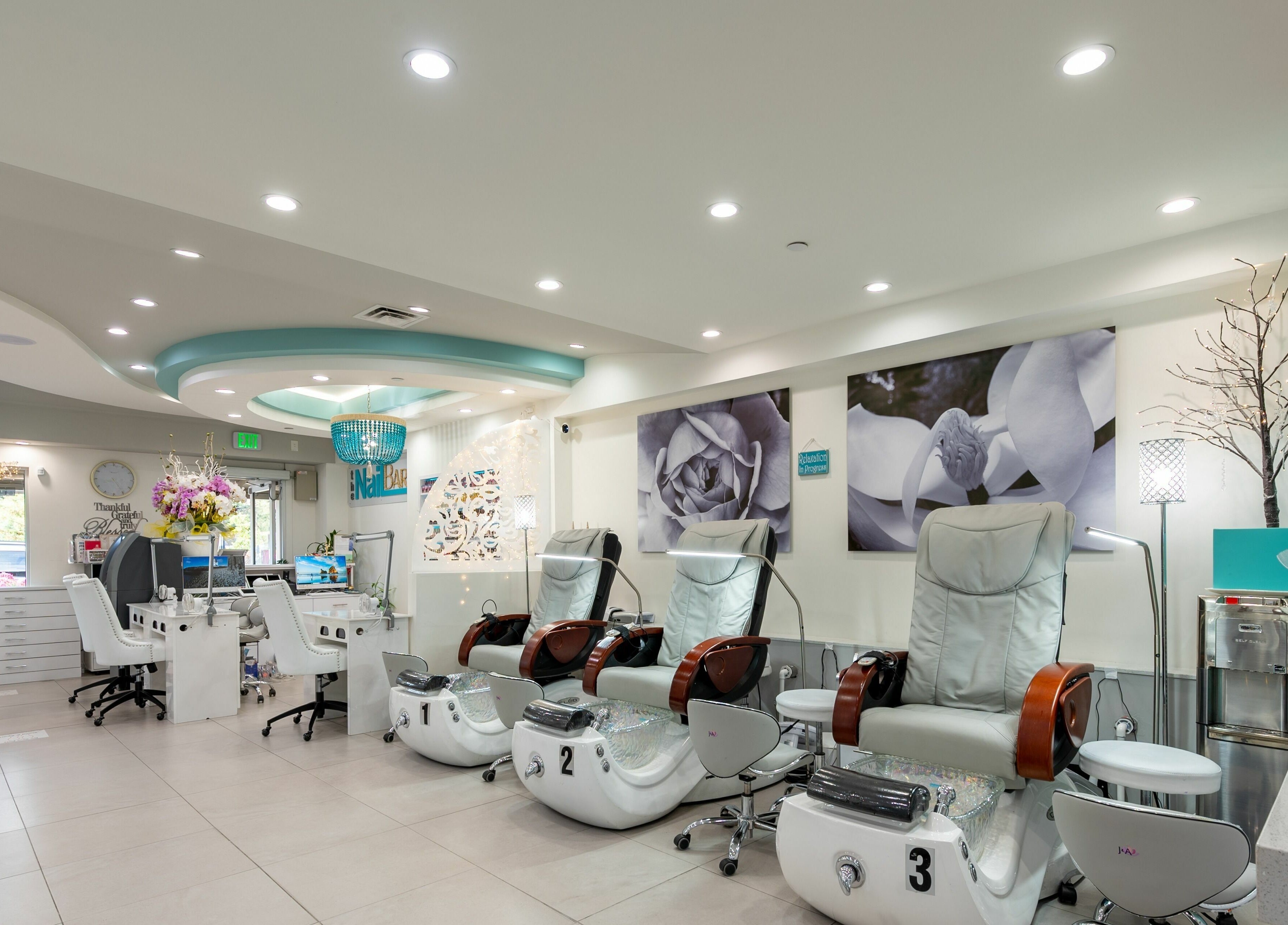 Luxurious interior of The Nail Bar Los Altos, California, US, featuring modern pedicure chairs.