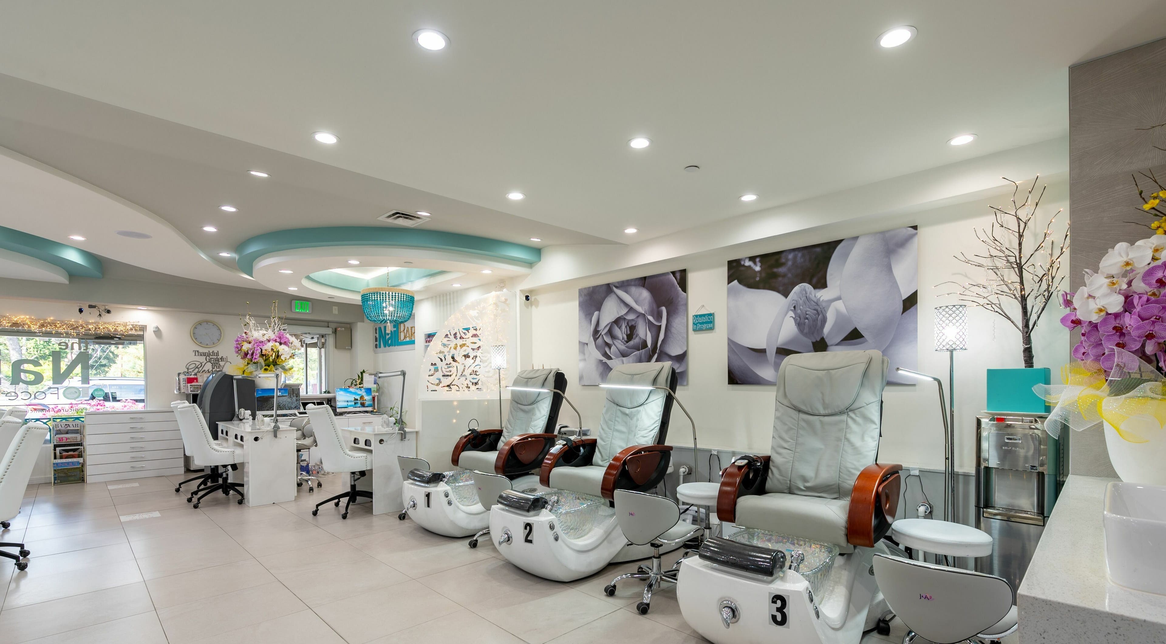 Luxurious interior of The Nail Bar Los Altos, California, US, featuring modern pedicure chairs.