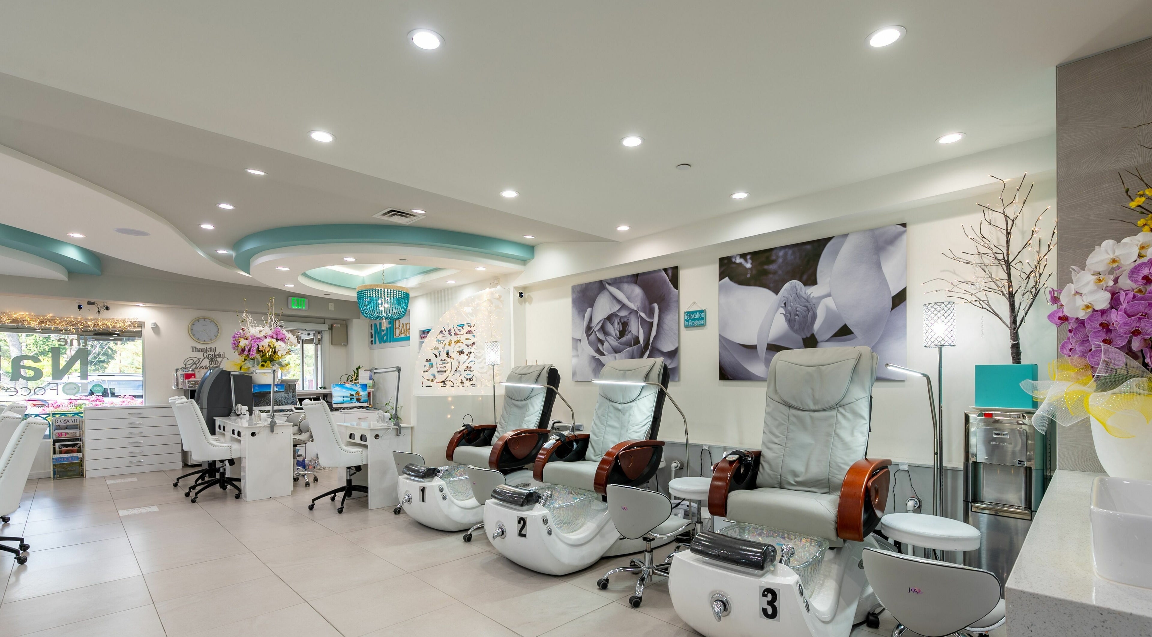 Luxurious interior of The Nail Bar Los Altos, California, US, featuring modern pedicure chairs.