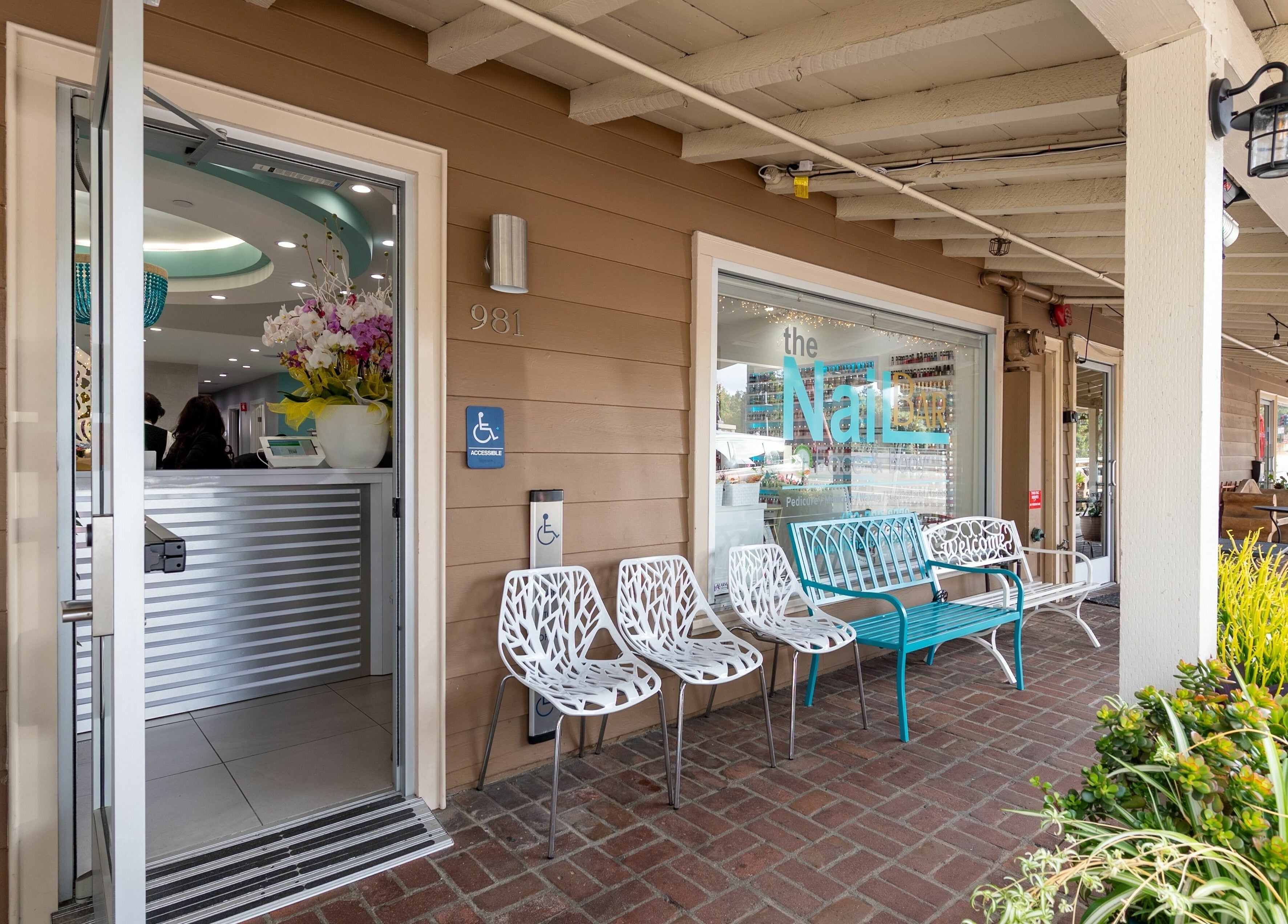Entrance of The Nail Bar Los Altos in Los Altos, California, US, showcasing stylish seating and vibrant decor.