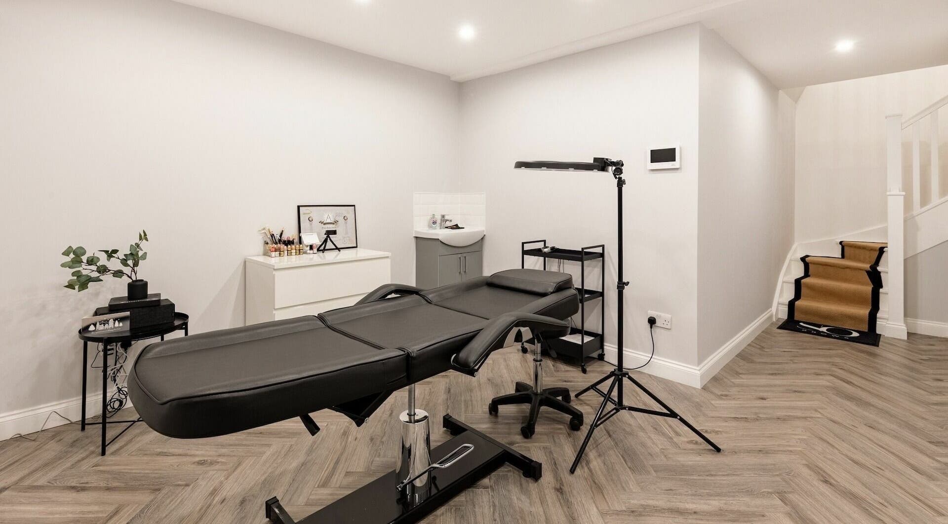 Modern treatment room at SO Brows, London, England, GB with sleek decor and a comfortable beauty bed.
