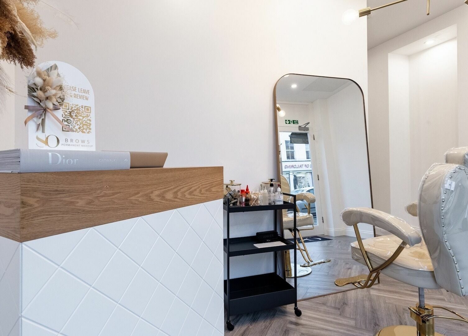 Interior of SO Brows, London, England, GB, showing a plush chair and well-kept workspace for beauty treatments.