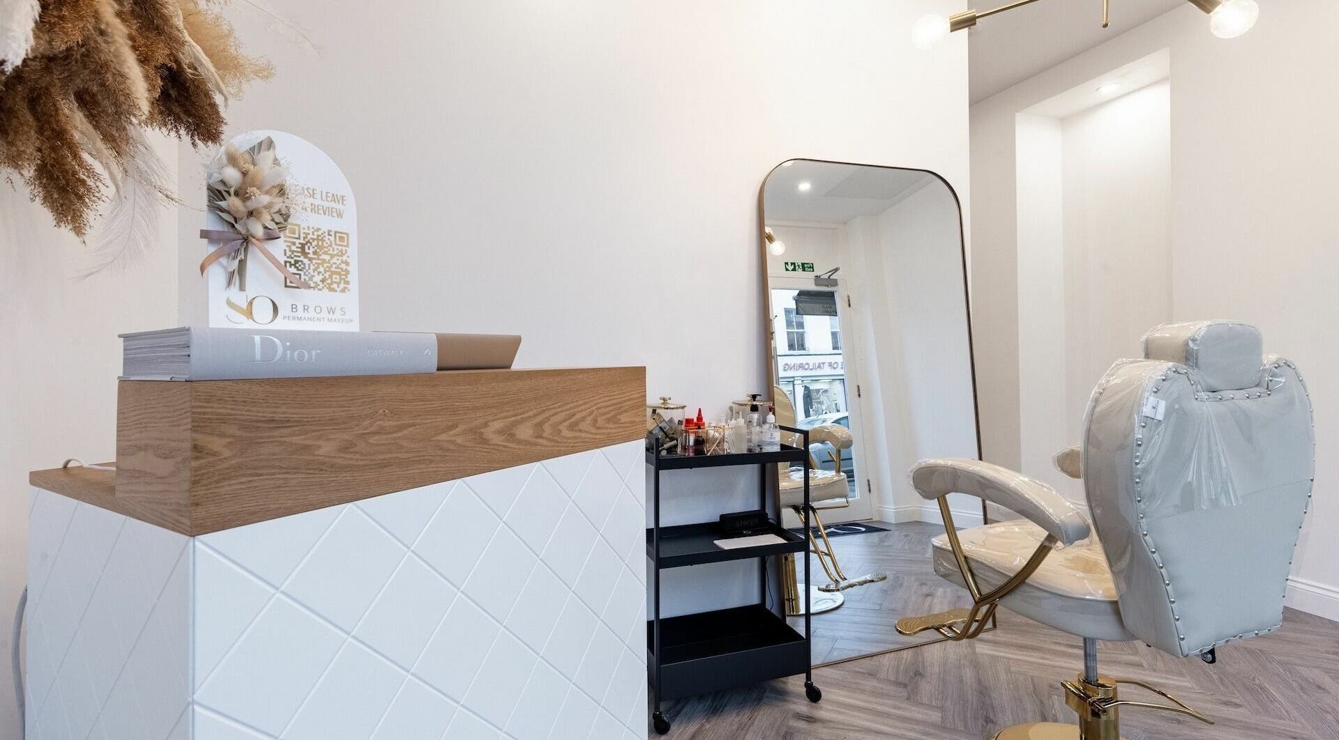 Interior of SO Brows, London, England, GB, showing a plush chair and well-kept workspace for beauty treatments.