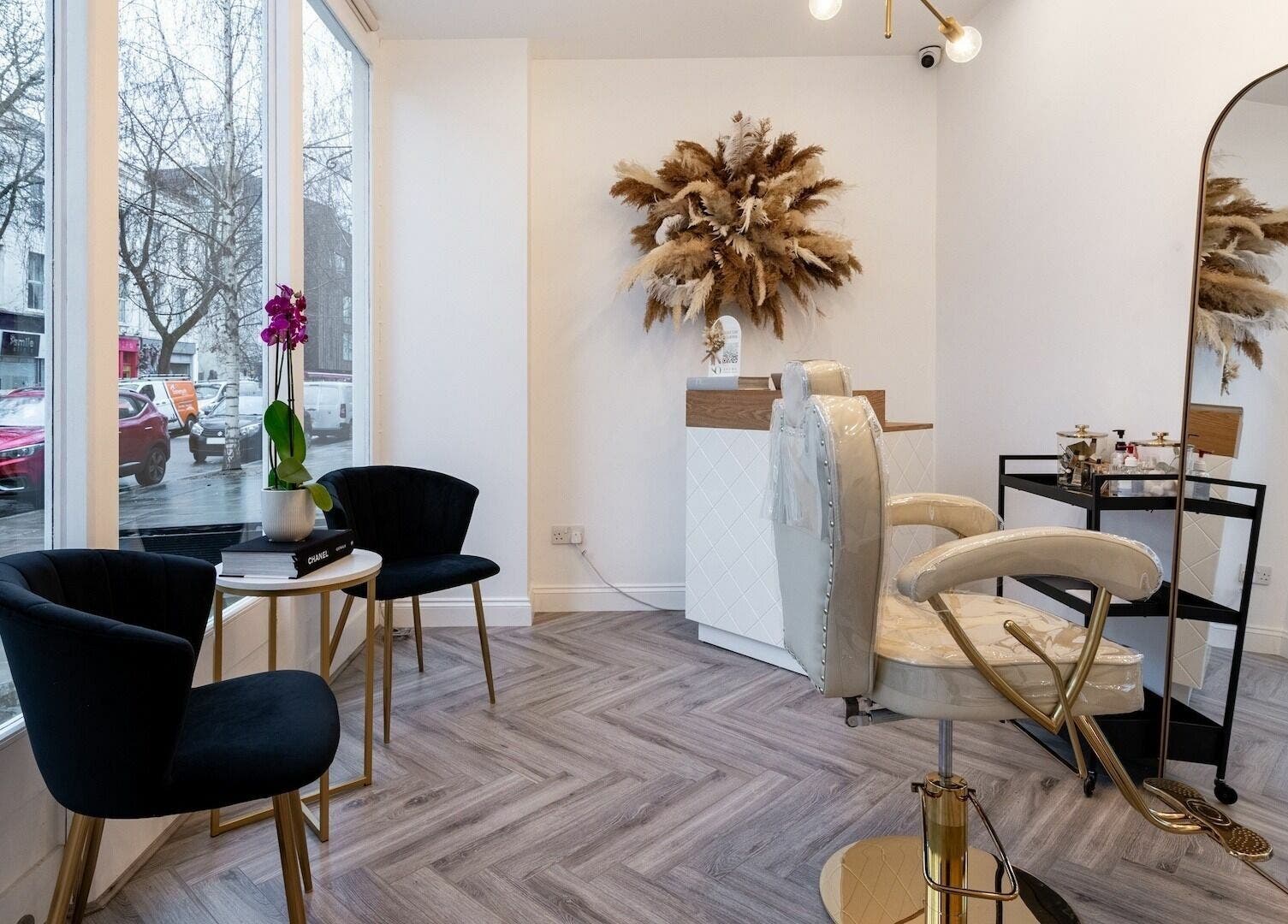 Modern and elegant beauty salon interior at SO Brows, London, England, GB with stylish decor and plush seating.