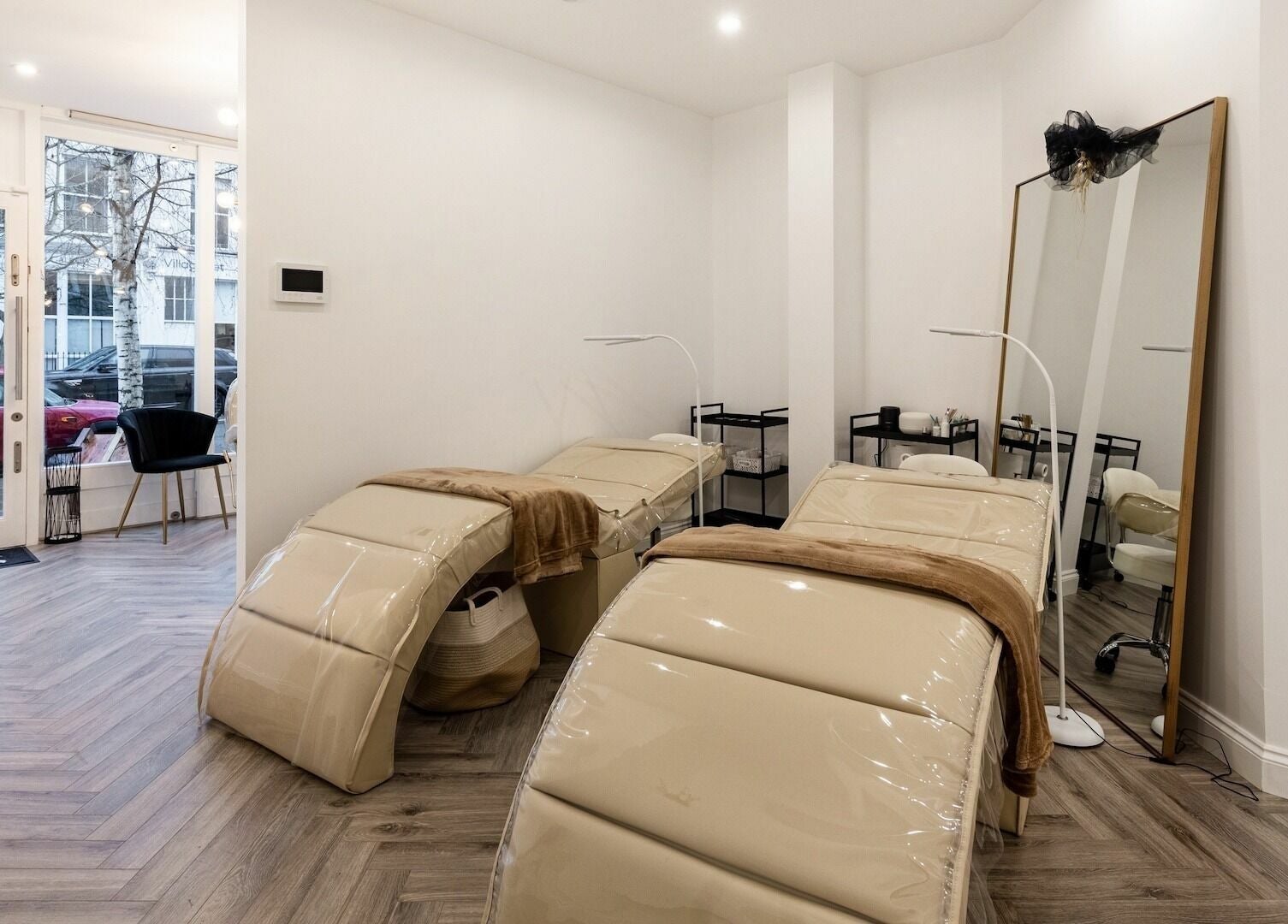 Luxury treatment beds at SO Brows, London, England, GB, offering a serene beauty and wellness experience.