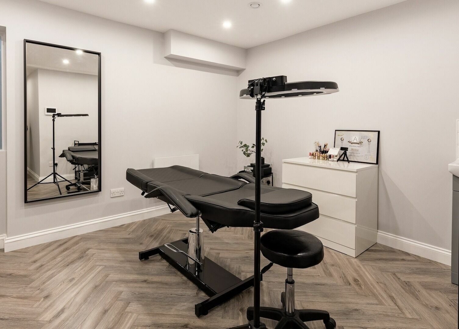 Elegant beauty room at SO Brows, London, England, GB with modern decor and sleek black treatment chair.
