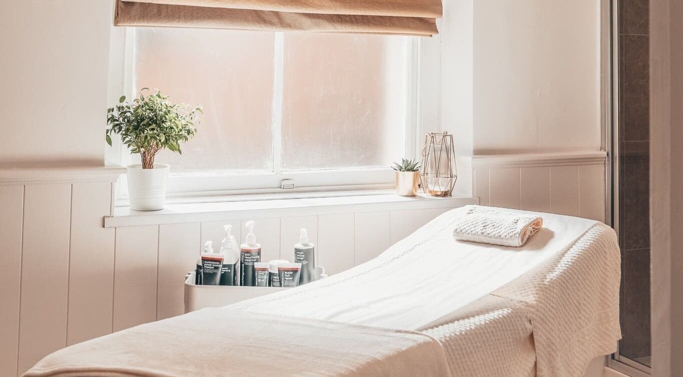 Tranquil spa room at The Ivy Beauty Lounge, Minehead, England, GB, with a cozy treatment bed and soft lighting.