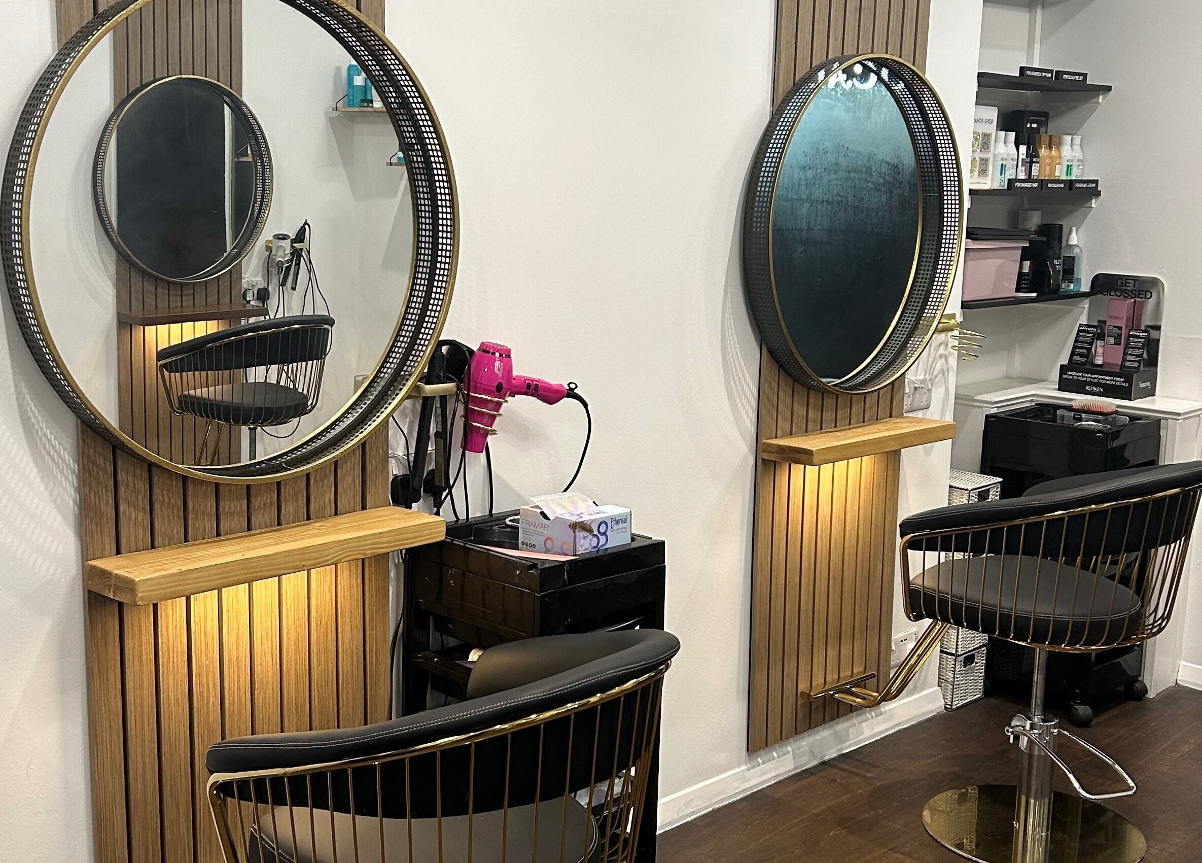 Strands salon Newport Pagnell -Jen features chic hairstyling stations with mirrors, chairs, and products in Newport Pagnell, England, GB.