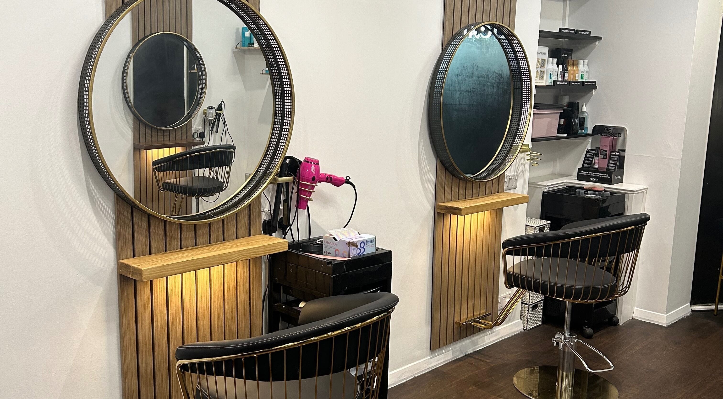 Strands salon Newport Pagnell -Jen features chic hairstyling stations with mirrors, chairs, and products in Newport Pagnell, England, GB.