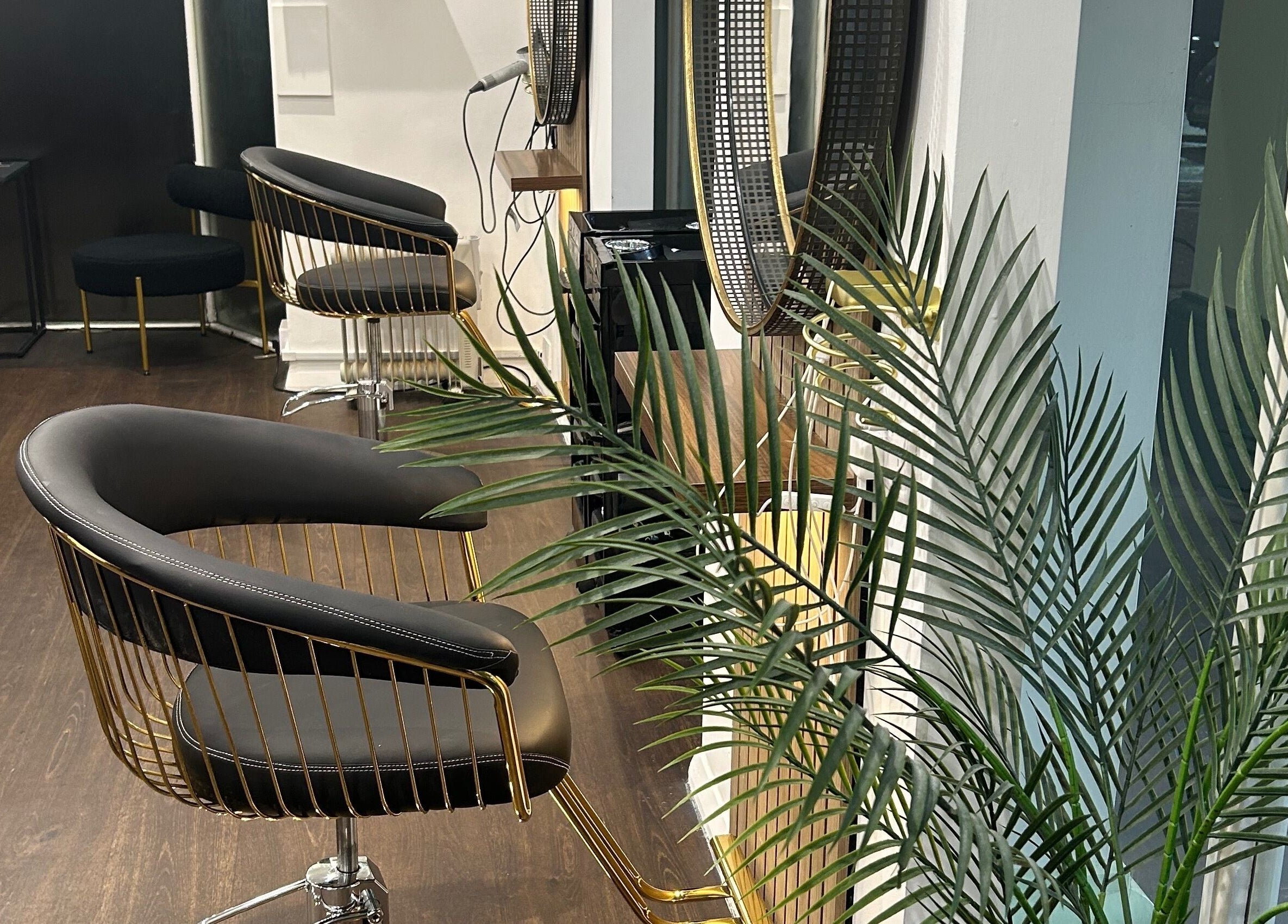 Modern salon chairs and mirrors at Strands salon Newport Pagnell -Jen, Newport Pagnell, England, GB.