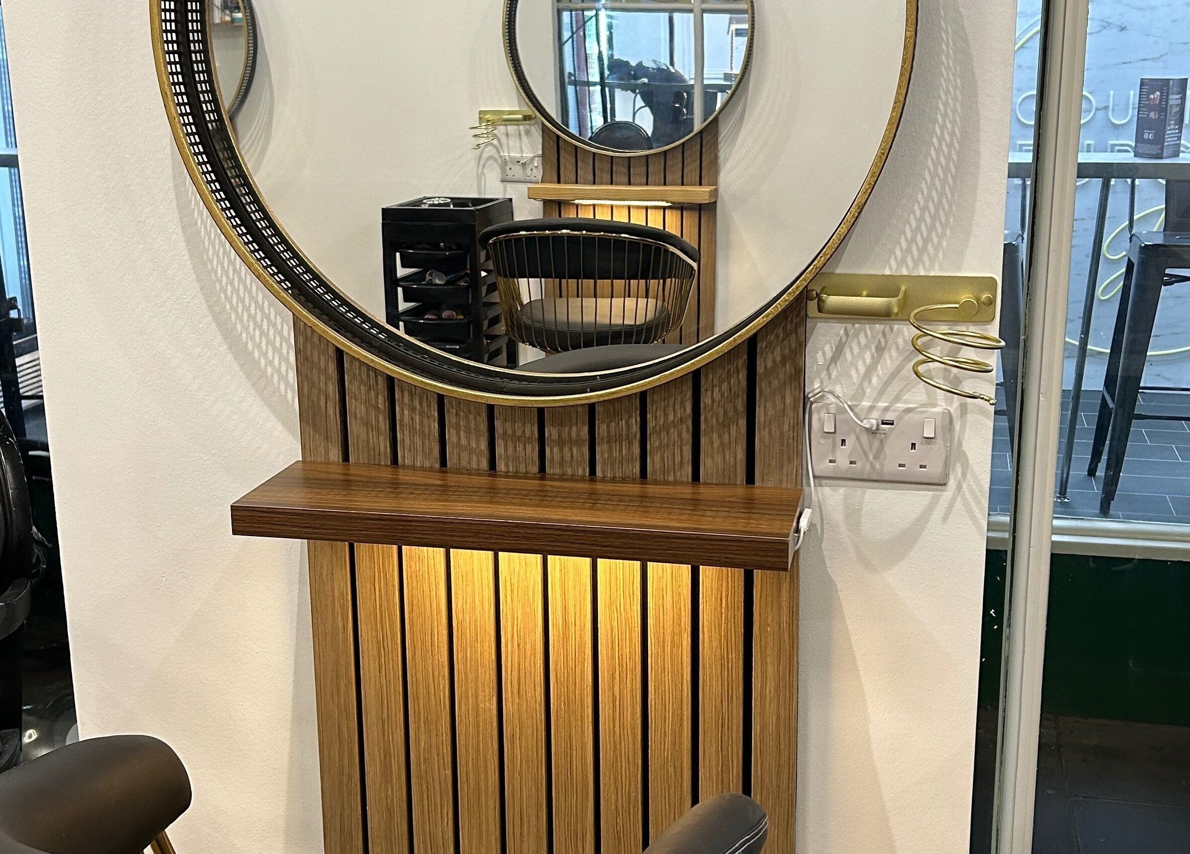 Chic interior of Strands salon Newport Pagnell -Jen featuring a stylish mirror and modern chairs in Newport Pagnell, England, GB.