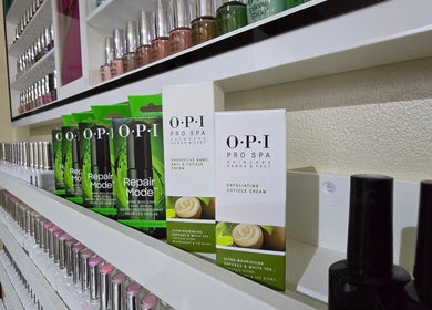 Nail care products on display at Salon 971 in Dubai, Dubai, AE, featuring OPI Pro Spa creams and polishes.