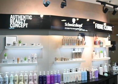 Salon 971 in Dubai, Dubai, AE displays premium beauty products on stylish shelves.