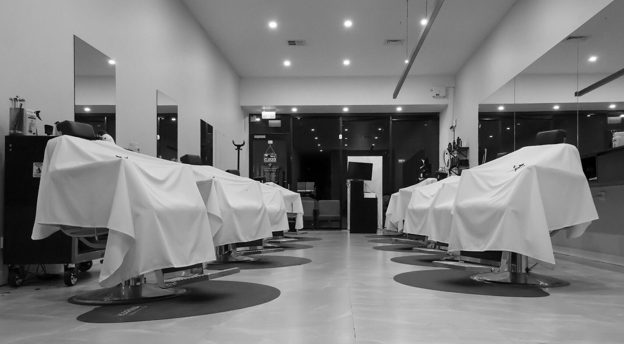 Sleek interior of Empire Barbershop in Melbourne, Victoria, AU, featuring modern barber chairs and lighting.