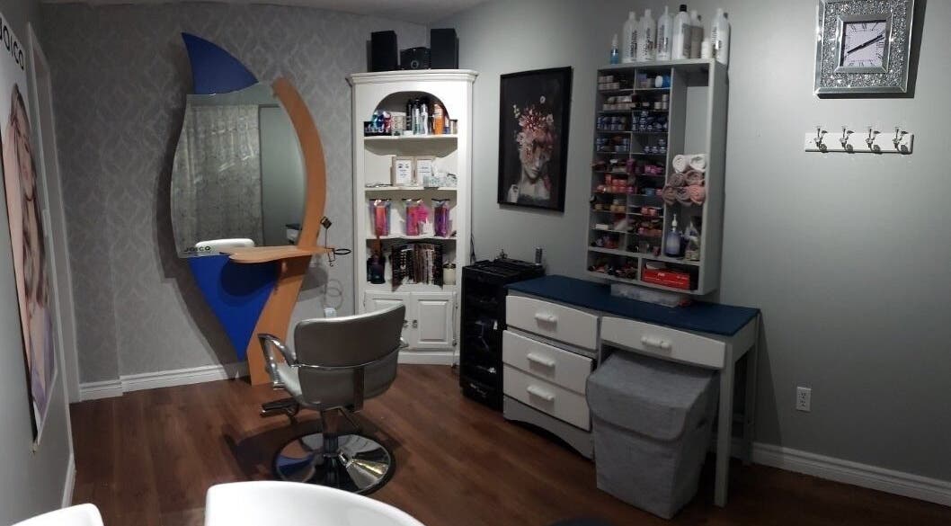 Modern styling station at Rebekka's Hair Salon in Ramara, Ontario, CA, featuring sleek decor and organized shelves.