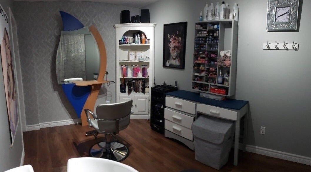 Modern styling station at Rebekka's Hair Salon in Ramara, Ontario, CA, featuring sleek decor and organized shelves.