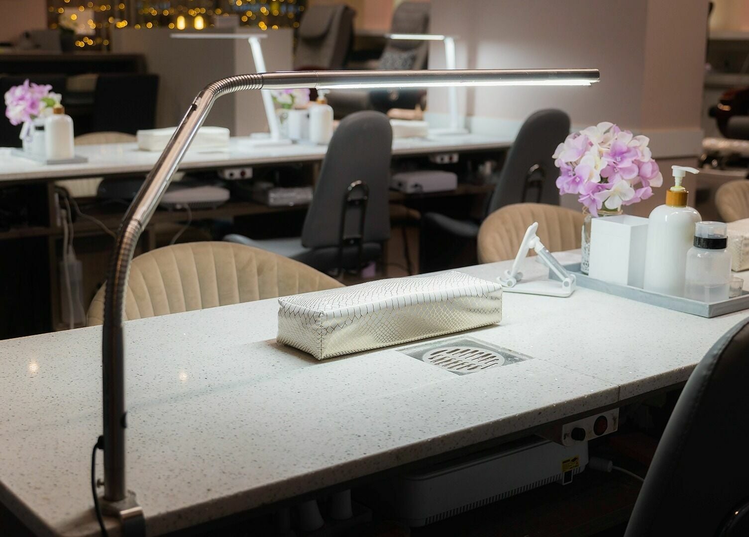 Elegant manicure stations at Nail One & Spa, Markham, Ontario, CA, featuring modern lighting and decor.
