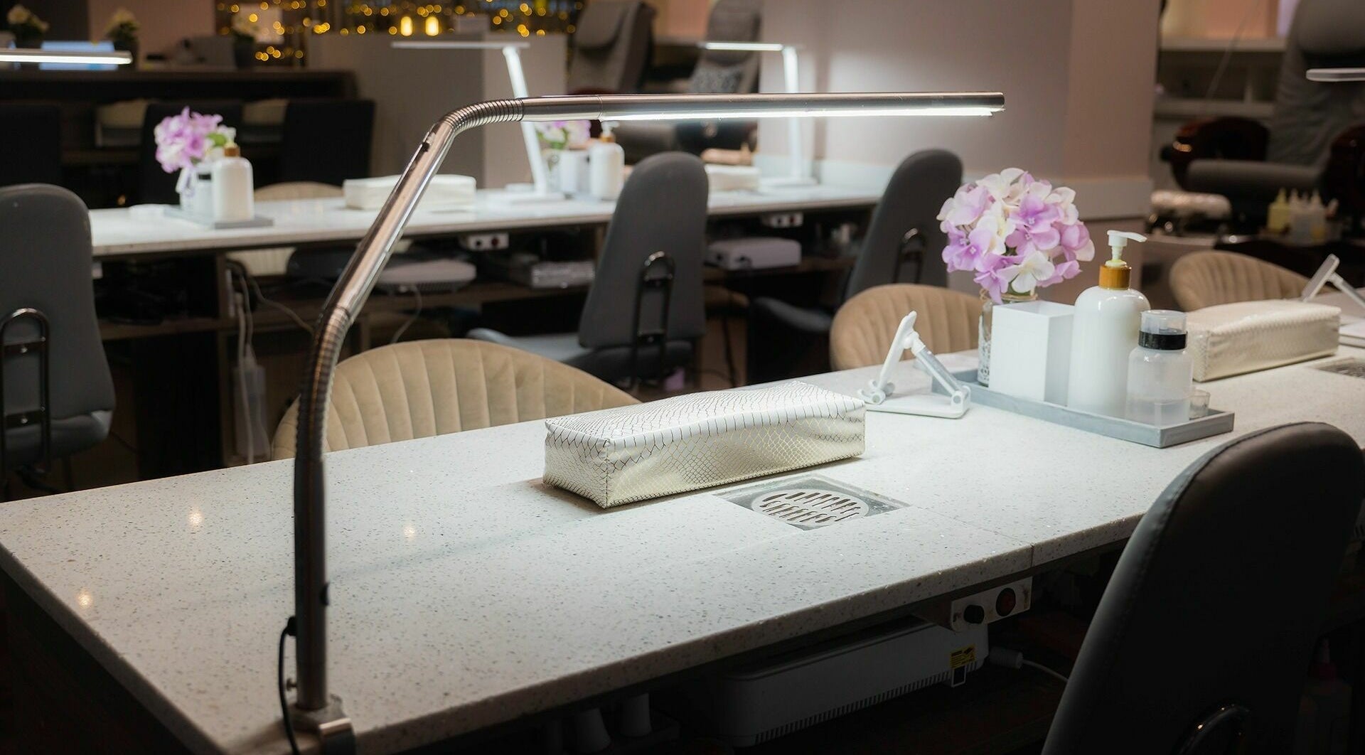 Elegant manicure stations at Nail One & Spa, Markham, Ontario, CA, featuring modern lighting and decor.