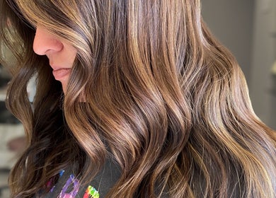 Brunette hair with highlights styled in waves at Bridget Nottingham Hair Design, Huntington Beach, California, US.
