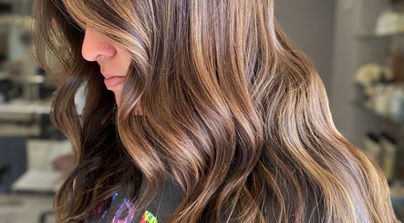Brunette hair with highlights styled in waves at Bridget Nottingham Hair Design, Huntington Beach, California, US.