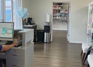 Reception area at De'Bleu Hair Salon and Spa, Savannah, Grand Cayman, KY, showcasing a modern and inviting interior.